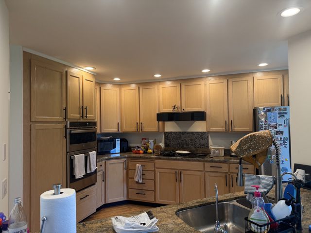 Kitchen overall view with oak cabinets and granite