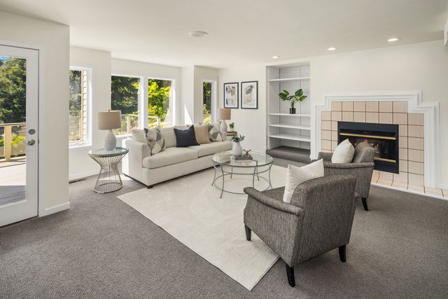 Rec room fireplace flanked by white built-in shelves